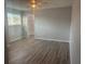 Spacious bedroom featuring hardwood floors, closet and bright window at 6520 Thicket Trl, New Port Richey, FL 34653