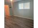Bright bedroom featuring hardwood floors, closet and bright window at 6520 Thicket Trl, New Port Richey, FL 34653