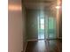 Living room featuring hardwood floors, sliding glass doors, and a ceiling fan at 6520 Thicket Trl, New Port Richey, FL 34653