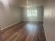 Spacious living room with hardwood floors and a large window at 6520 Thicket Trl, New Port Richey, FL 34653