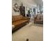 Cozy living room featuring stylish furniture, neutral carpet, and decor with seamless flow to the kitchen at 6520 Thicket Trl, New Port Richey, FL 34653