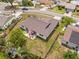 Aerial view of a well-maintained home with a backyard patio, surrounded by lush greenery and neighboring properties at 6826 Rosemary Dr, Tampa, FL 33625