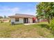 Spacious backyard with a patio, outdoor seating, and lush green grass, ideal for outdoor enjoyment at 6826 Rosemary Dr, Tampa, FL 33625