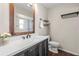 Bathroom featuring a dark wood framed mirror, white counter, and a toilet at 6826 Rosemary Dr, Tampa, FL 33625