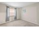 Empty bedroom with carpet, a window with curtains, and neutral colored walls at 6826 Rosemary Dr, Tampa, FL 33625