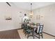 Well-lit dining area featuring a modern chandelier and a view into the kitchen at 6826 Rosemary Dr, Tampa, FL 33625
