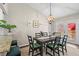 Inviting dining area with stylish lighting and views of the kitchen and backyard at 6826 Rosemary Dr, Tampa, FL 33625
