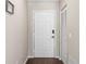 Welcoming entryway with a white front door, closet, and sleek flooring, creating a clean and inviting ambiance at 6826 Rosemary Dr, Tampa, FL 33625