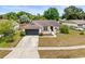 Charming single-story home with a well-manicured lawn, beautiful landscaping, and a two-car garage at 6826 Rosemary Dr, Tampa, FL 33625