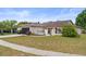 Charming single-story home with a dark-colored garage door, well-maintained lawn, and cozy front yard at 6826 Rosemary Dr, Tampa, FL 33625