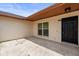 Inviting front porch with a concrete slab and a stylish black front door, offering a welcoming entrance at 6826 Rosemary Dr, Tampa, FL 33625