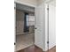 Hallway view into a bedroom with carpet, a window, and neutral colored walls at 6826 Rosemary Dr, Tampa, FL 33625