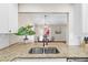 Bright kitchen featuring granite countertops and stainless steel sink overlooking the dining area at 6826 Rosemary Dr, Tampa, FL 33625