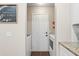 Convenient laundry area with a washer, dryer, and door, easily accessible, ensuring efficient chores at 6826 Rosemary Dr, Tampa, FL 33625
