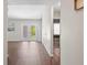 Bright living room with wood flooring, French doors to the backyard, and views into the adjacent rooms at 6826 Rosemary Dr, Tampa, FL 33625