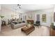 Open-concept living room and dining area with neutral tones, lots of natural light and outdoor access at 6826 Rosemary Dr, Tampa, FL 33625