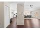 Open-concept living space with hardwood floors, a dining area, and a glimpse into the kitchen, perfect for entertaining at 6826 Rosemary Dr, Tampa, FL 33625