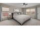 This is a main bedroom with a neutral decor, a ceiling fan, and two windows at 6826 Rosemary Dr, Tampa, FL 33625