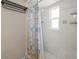 This is a shower with gray and white tile and a shower curtain at 6826 Rosemary Dr, Tampa, FL 33625
