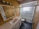 Well-lit bathroom with a vanity and enclosed shower-tub combination at 7001 86Th N Ave, Pinellas Park, FL 33782