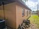 Side view of the home including view of windows, back yard and partial AC unit at 7001 86Th N Ave, Pinellas Park, FL 33782