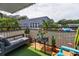 Relaxing outdoor balcony featuring a comfortable loveseat and potted plants with neighborhood view at 704 Lyndhurst St # 624, Dunedin, FL 34698