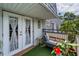 A cozy balcony showcasing beautiful plants, outdoor seating, and a view of the surroundings at 704 Lyndhurst St # 624, Dunedin, FL 34698