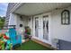Inviting balcony with colorful seating and tropical plants offers a charming outdoor space at 704 Lyndhurst St # 624, Dunedin, FL 34698