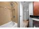 Updated bathroom with tiled shower/tub combo, vanity with dark countertop, and neutral color scheme at 704 Lyndhurst St # 624, Dunedin, FL 34698