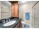 Bathroom with a glass-enclosed shower, dark granite countertop, and modern fixtures at 704 Lyndhurst St # 624, Dunedin, FL 34698