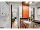 Bathroom with granite countertops and an adjacent laundry area, offering convenience at 704 Lyndhurst St # 624, Dunedin, FL 34698
