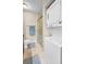 Bathroom with a shower, vanity, and stacked washer/dryer for added convenience at 704 Lyndhurst St # 624, Dunedin, FL 34698