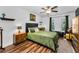 Bedroom features hardwood floors, fan, windows, sitting area, and ornate furniture at 704 Lyndhurst St # 624, Dunedin, FL 34698