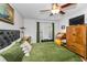 Comfortable bedroom featuring a tufted headboard, green bedding, and natural light at 704 Lyndhurst St # 624, Dunedin, FL 34698