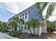 Charming exterior elevation with a well-manicured lawn and tropical plants around the property at 704 Lyndhurst St # 624, Dunedin, FL 34698