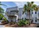 Lovely exterior view showcasing attractive landscaping, private balcony, and distinctive architectural style at 704 Lyndhurst St # 624, Dunedin, FL 34698