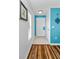 Entryway with tile and wood flooring, featuring turquoise accent wall at 704 Lyndhurst St # 624, Dunedin, FL 34698