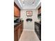 Kitchen features wood cabinets, dark granite countertops, track lighting and stainless appliances at 704 Lyndhurst St # 624, Dunedin, FL 34698