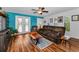 Inviting living room features with stylish wood floors, a ceiling fan, and ample seating at 704 Lyndhurst St # 624, Dunedin, FL 34698