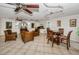 Spacious lounge with wicker seating, decorative art, and a dining table for flexible use at 704 Lyndhurst St # 624, Dunedin, FL 34698