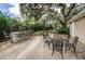 Beautifully landscaped outdoor patio featuring a stone bar and dining area ideal for gatherings at 704 Lyndhurst St # 624, Dunedin, FL 34698