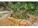 Outdoor water feature with rock accents surrounded by lush tropical foliage and decorative stones at 704 Lyndhurst St # 624, Dunedin, FL 34698