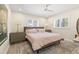 Comfortable bedroom with a wooden headboard, soft linens, and bright natural light from the two large windows at 743 43Rd Ne Ave, St Petersburg, FL 33703