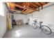 Spacious garage with gray painted floor, white walls, exposed ceiling, storage, and a bicycle at 743 43Rd Ne Ave, St Petersburg, FL 33703