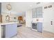 Open concept kitchen area with stainless steel wine fridge, glass cabinets, and light wood flooring at 743 43Rd Ne Ave, St Petersburg, FL 33703