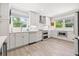 Modern kitchen featuring white cabinets, stainless steel appliances, and wood flooring at 743 43Rd Ne Ave, St Petersburg, FL 33703