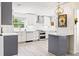 Modern kitchen featuring white cabinets, stainless steel appliances, and an island at 743 43Rd Ne Ave, St Petersburg, FL 33703