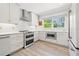 Bright kitchen featuring white cabinets, quartz countertops, and stainless appliances at 743 43Rd Ne Ave, St Petersburg, FL 33703