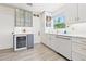 Elegant kitchen with a wine fridge, glass cabinets, marble countertops, and modern hardware at 743 43Rd Ne Ave, St Petersburg, FL 33703