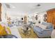 Comfortable living room showcasing hardwood floors, neutral paint, light blue accent chairs, and lots of light at 743 43Rd Ne Ave, St Petersburg, FL 33703